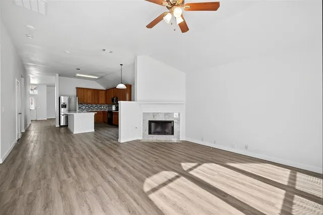 a view of a kitchen with a sink and a fireplace