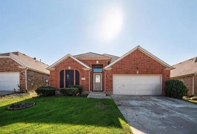 a front view of house with a garden