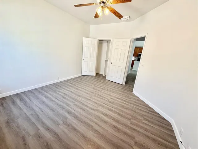 a view of a hallway with wooden floor