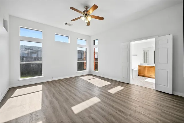 wooden floor in an empty room with a window