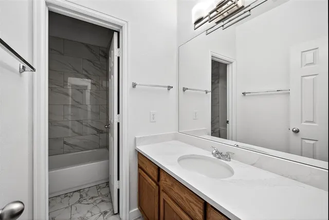 a bathroom with a bathtub and a sink