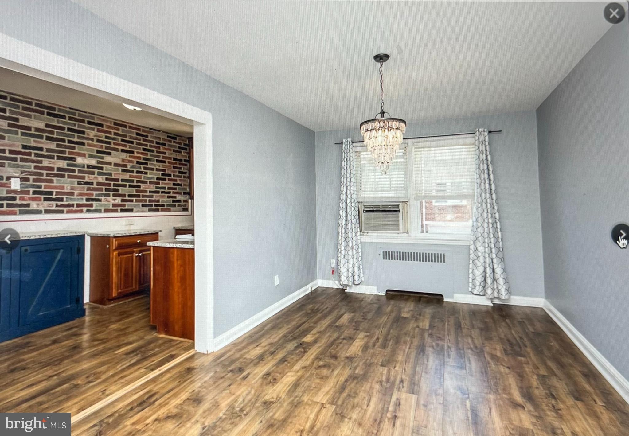 738 Eaton Road Drexel Hill, PA 19026 - Photo 5 of 16 a view of an empty room with window and wooden floor