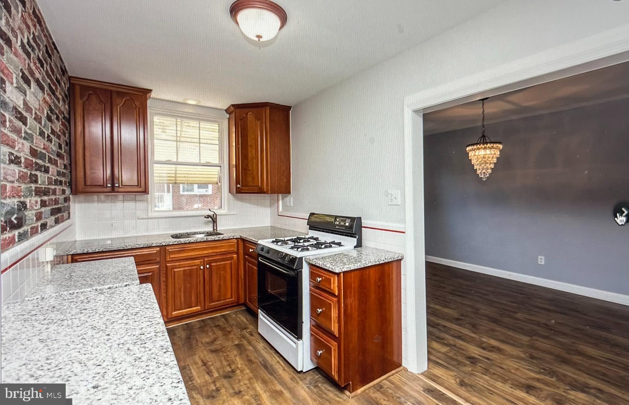738 Eaton Road Drexel Hill, PA 19026 - Photo 7 of 16 a kitchen with stainless steel appliances granite countertop a stove a sink and a microwave