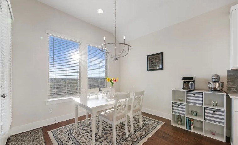 344 Pisa Lane Georgetown, TX 78628 - Photo 14 of 39 Gleaming hardwood floors and a lofty vaulted ceiling elevate this sunlit dining area.