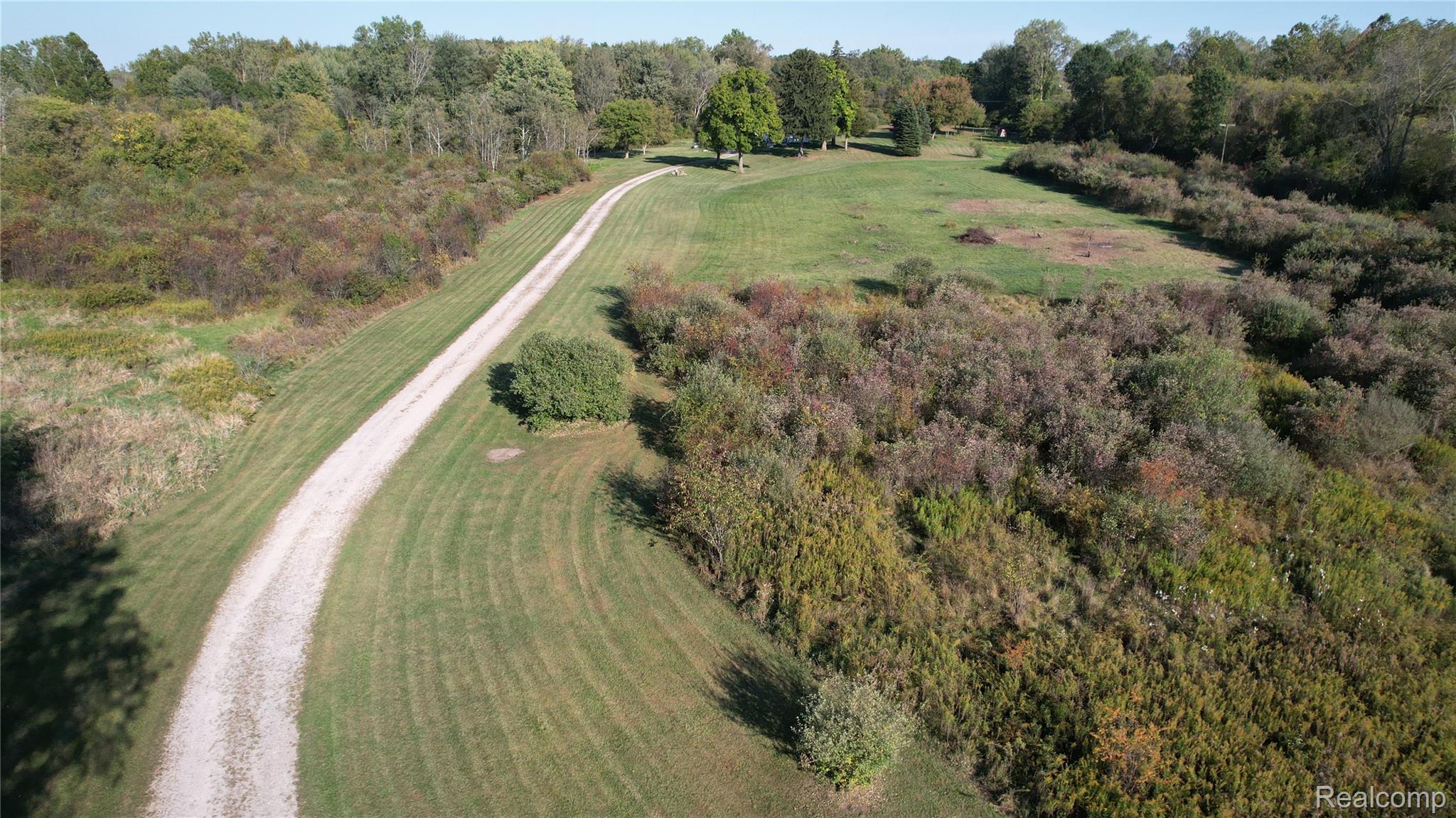 27901 Brandes Road Flat Rock, MI 48134 - Photo 2 of 38 Extensive natural landscape featuring a long gravel driveway, manicured lawns, and mature trees