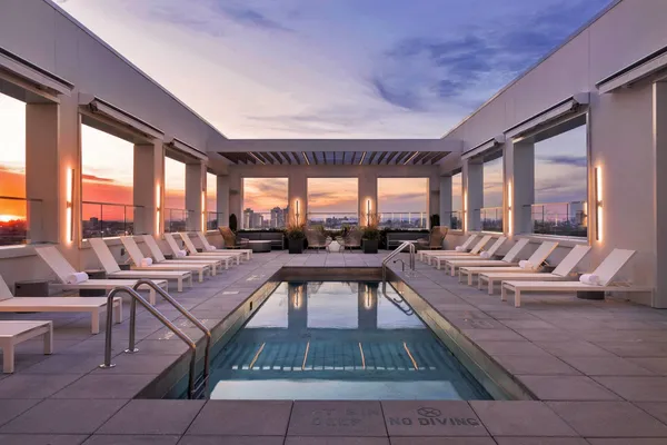 a living room with patio furniture and a large window