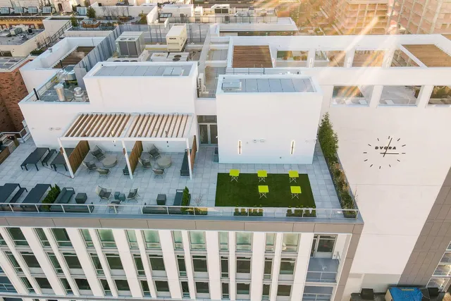 a view of a balcony with two chairs and a potted plant
