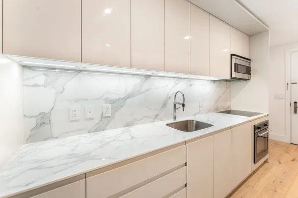 a close view of sink and cabinets