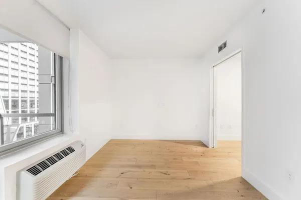a view of an empty room with a window