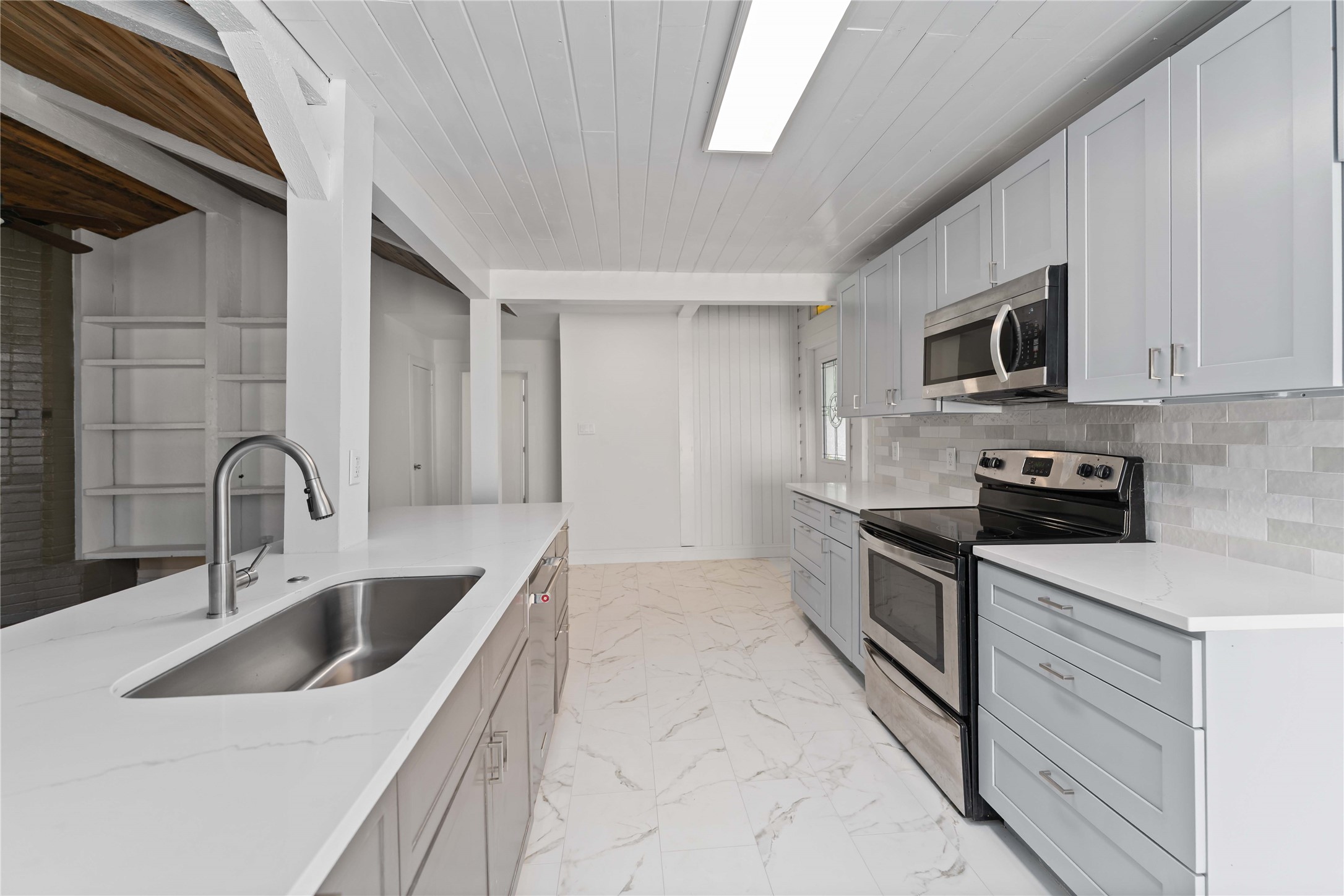 23122 Whispering Willow Drive Spring, TX 77373 - Photo 6 of 16 a kitchen with stainless steel appliances granite countertop a sink and stove top oven