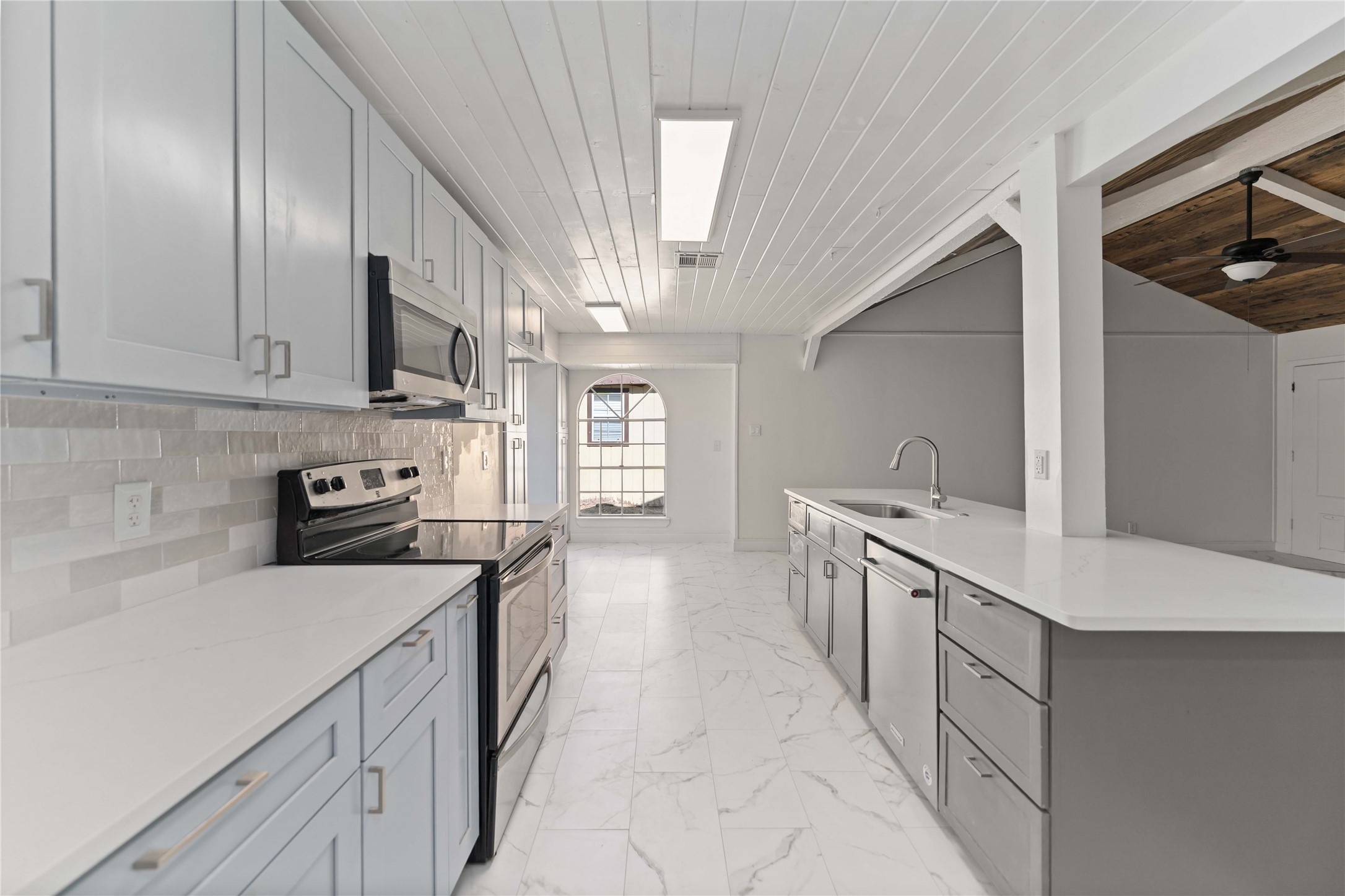 23122 Whispering Willow Drive Spring, TX 77373 - Photo 7 of 16 a kitchen with stainless steel appliances sink stove microwave and cabinets