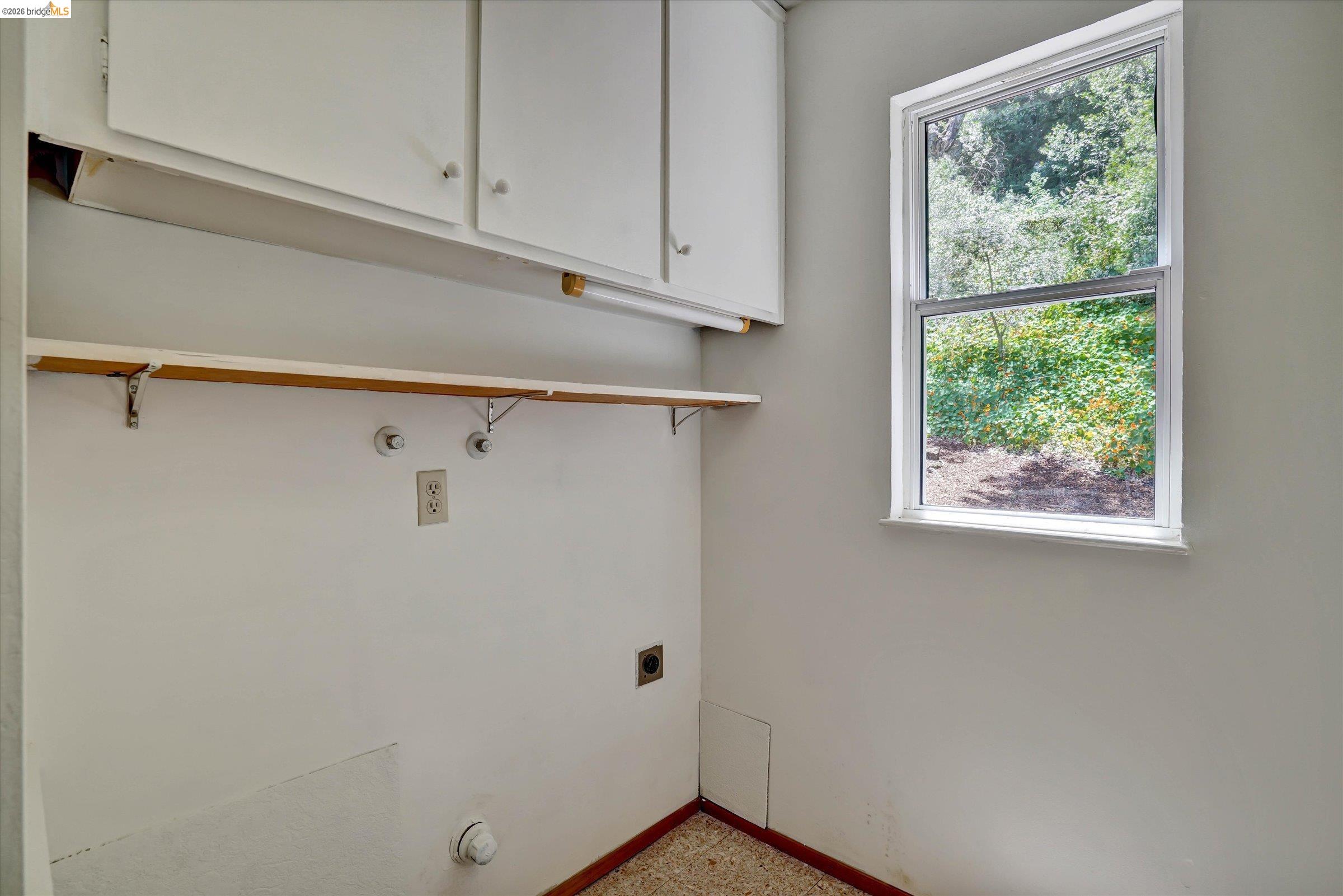 2826 Wright Avenue Pinole, CA 94564 - Photo 30 of 70 Utility area featuring wall-mounted cabinetry, a built-in shelf, and a window overlooking natural scenery