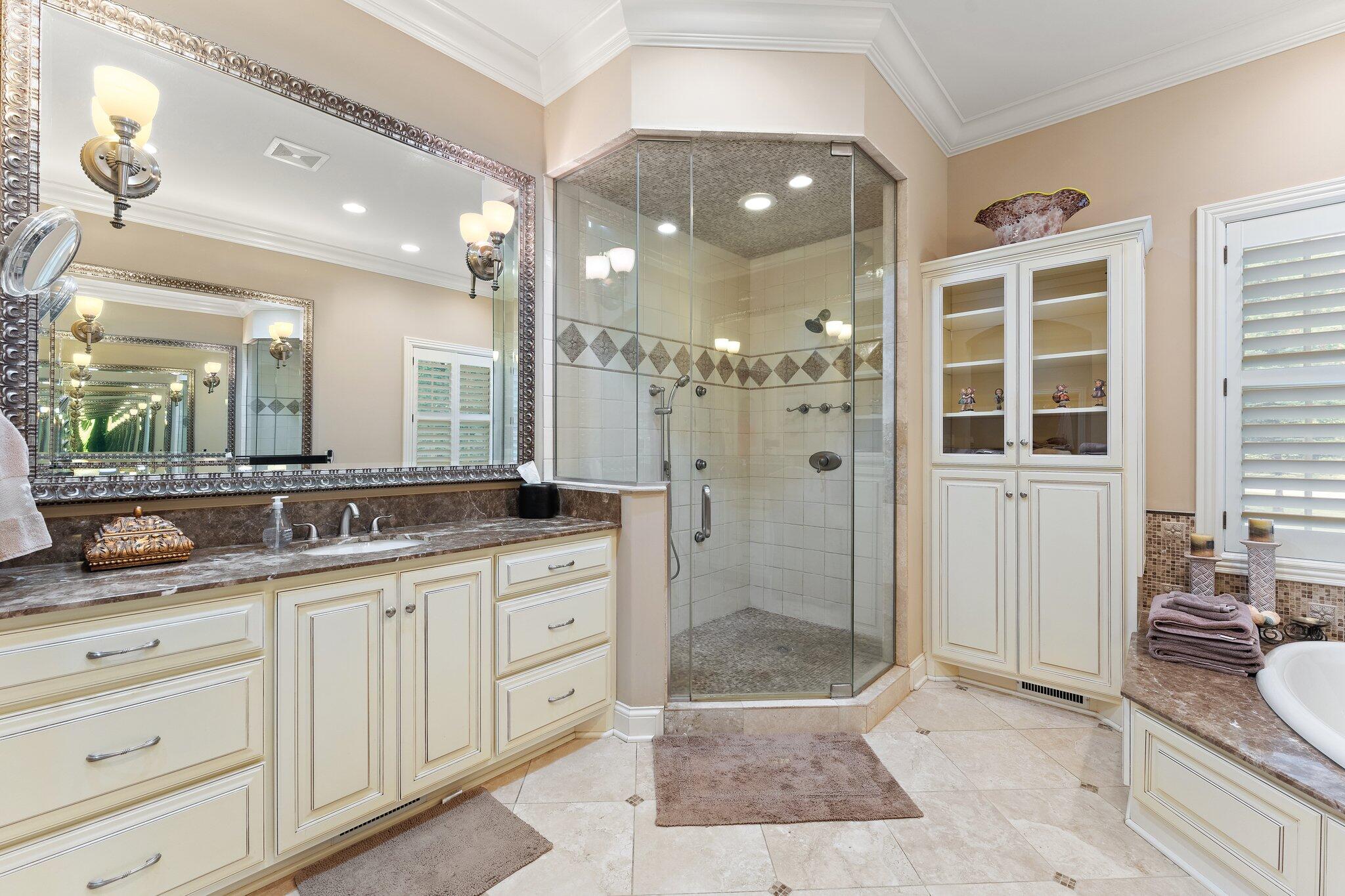 1191 Churchill Lane Crown Point, IN 46307 - Photo 34 of 80 a spacious bathroom with a granite countertop sink mirror and shower