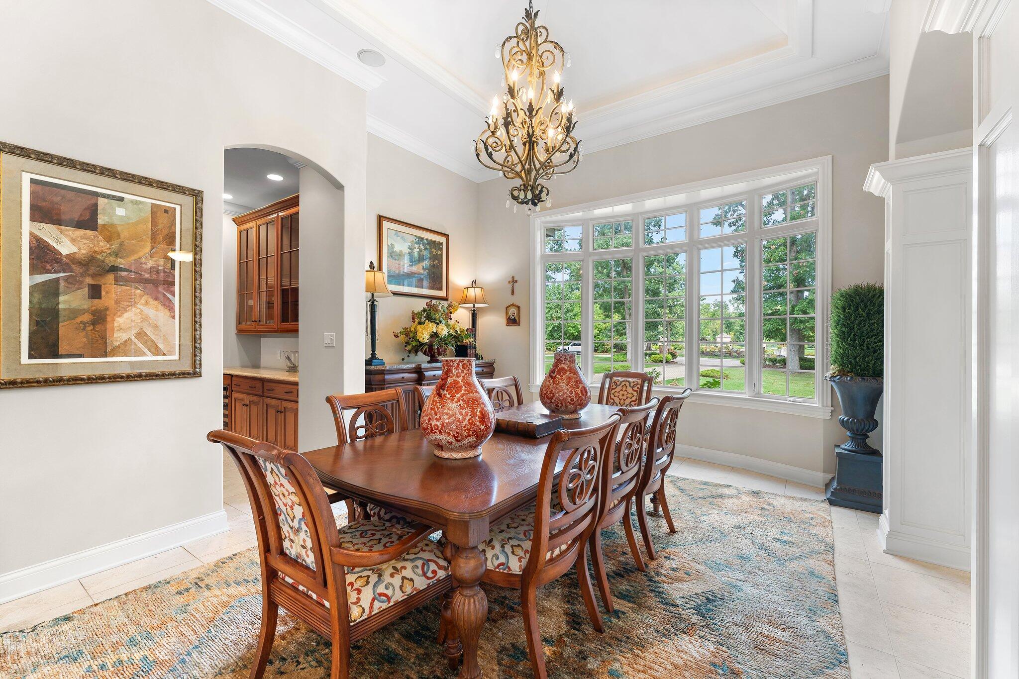 1191 Churchill Lane Crown Point, IN 46307 - Photo 10 of 80 a dining room with furniture a large window and a chandelier