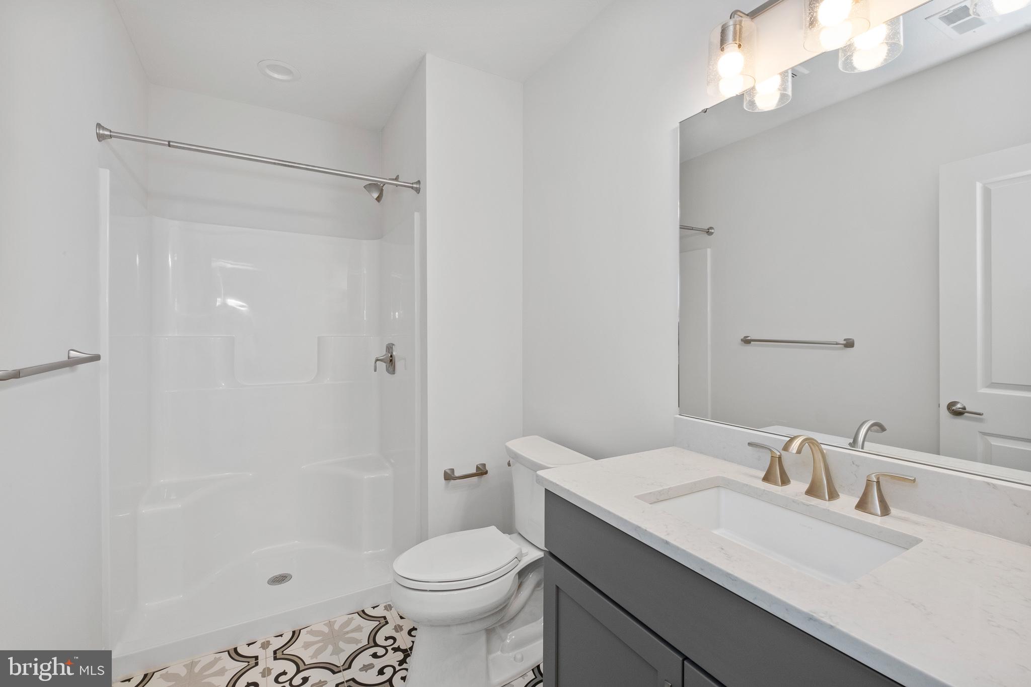 510 Newcomen Road, Unit R1D Exton, PA 19341 - Photo 40 of 51 a bathroom with a sink toilet vanity and shower