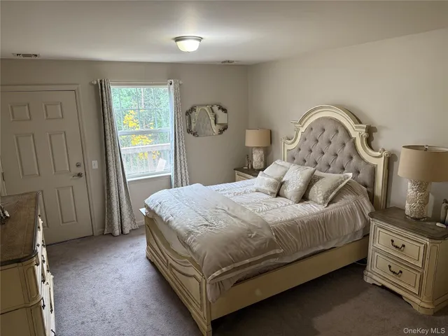 a bed sitting in a bedroom next to a window