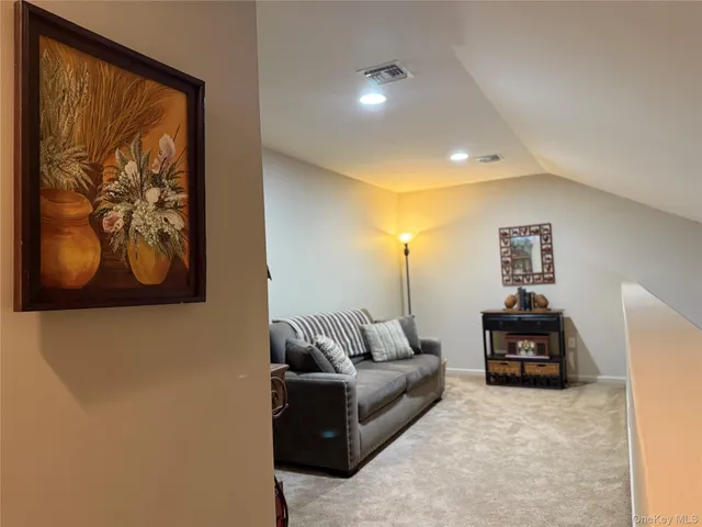 a living room with furniture and wall paintings