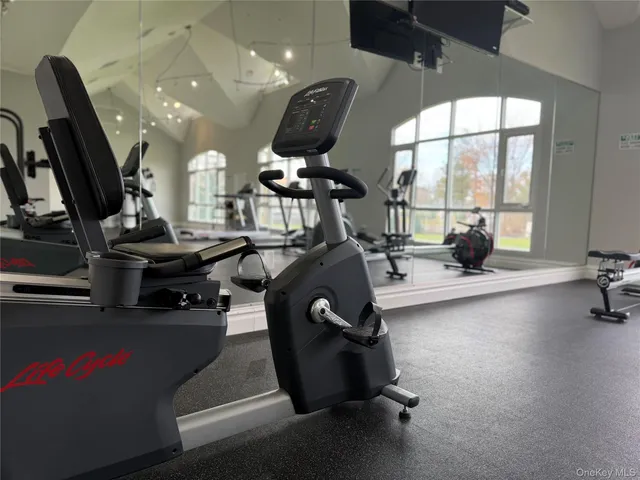 a room with gym equipment and a large window