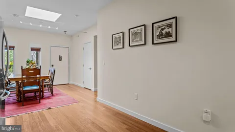 a kitchen with cabinets and wooden floor