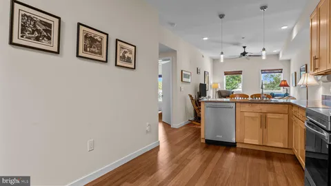 a kitchen with granite countertop a refrigerator stove and sink