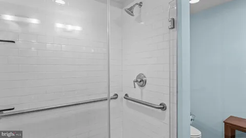 a view of storage and utility room with wooden floor