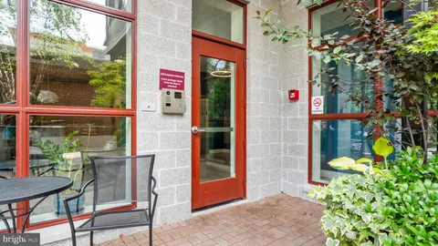 a front view of a house with outdoor seating and a potted plant