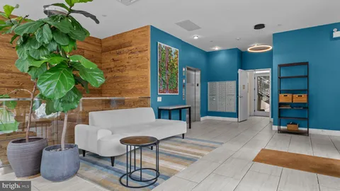 a view of an entryway with a floor to ceiling window and dining room