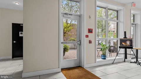 a view of a patio with couches and chairs under an umbrella