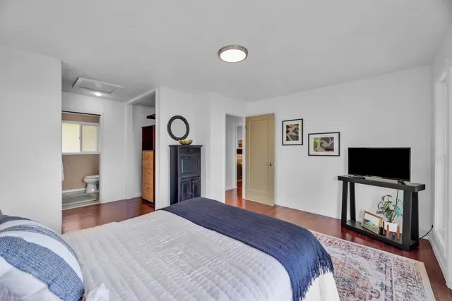 a bedroom with a bed and a television