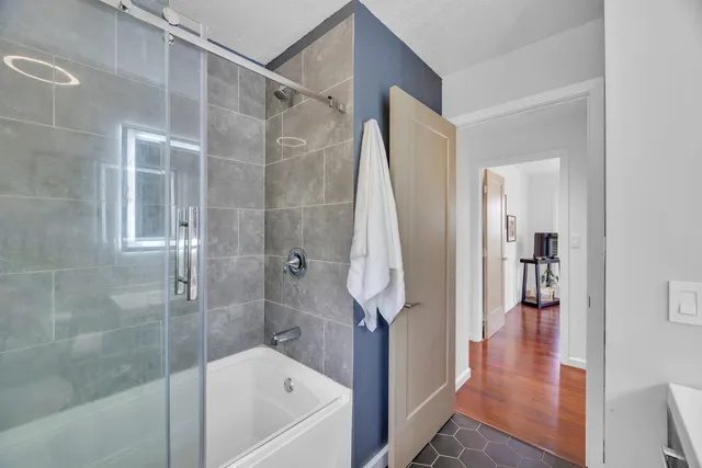 a bathroom with a bathtub and a shower