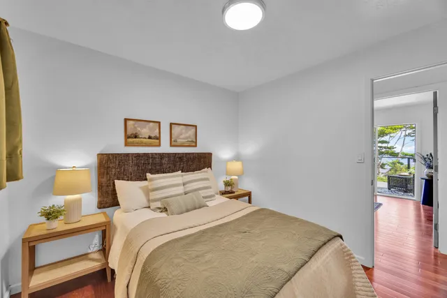 a bedroom with a bed and a lamp