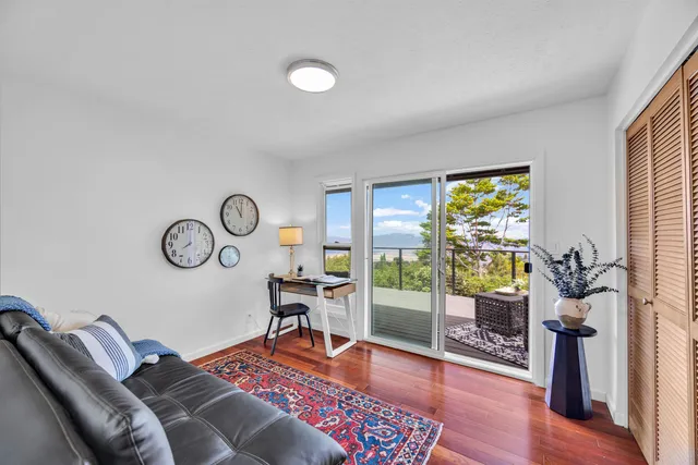 a living room with furniture a rug and a window