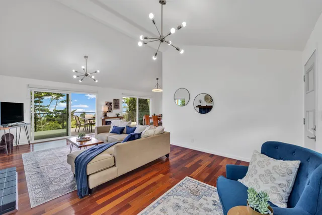 a living room with furniture and a chandelier