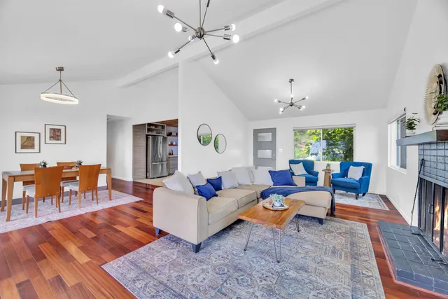 a living room with furniture a fireplace and a table