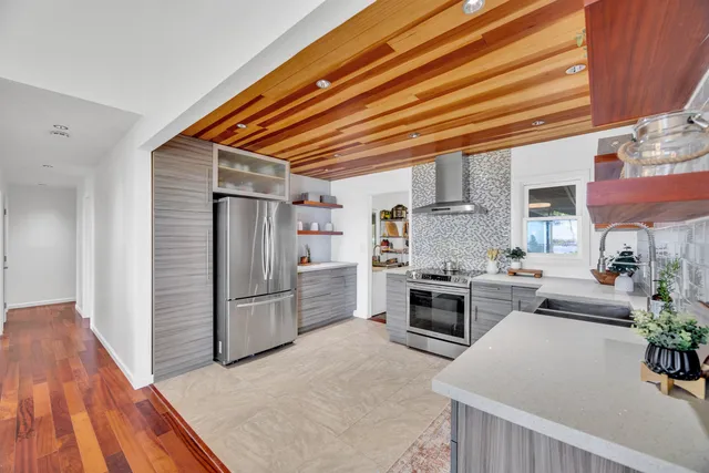 a kitchen with refrigerator and cabinets
