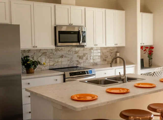 a kitchen with a sink and a stove top oven
