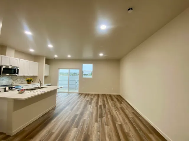 a kitchen with stainless steel appliances a refrigerator sink and microwave