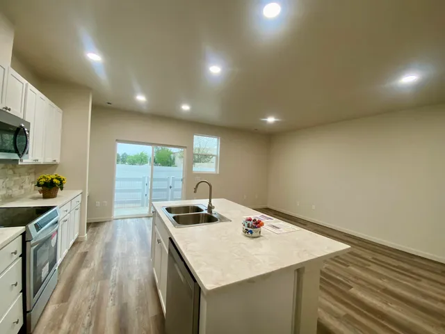 a kitchen that has a sink and a stove