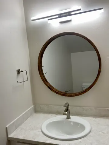 a bathroom with a sink and mirror