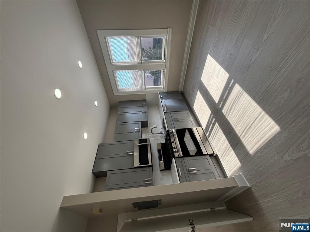 a kitchen with stainless steel appliances granite countertop a refrigerator and a stove top oven