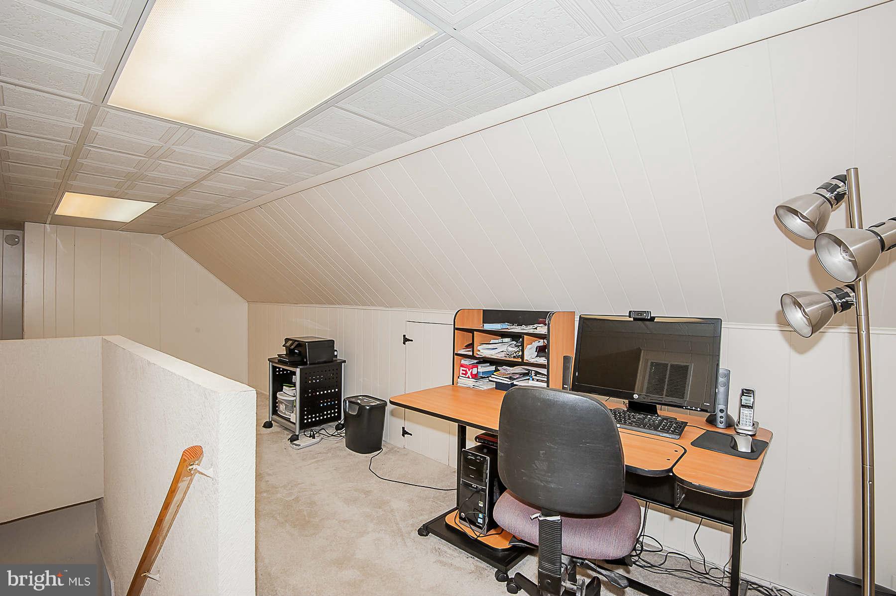 3602 Landbeck Road Baltimore, MD 21207 - Photo 22 of 30 a view of a workspace with furniture and a window
