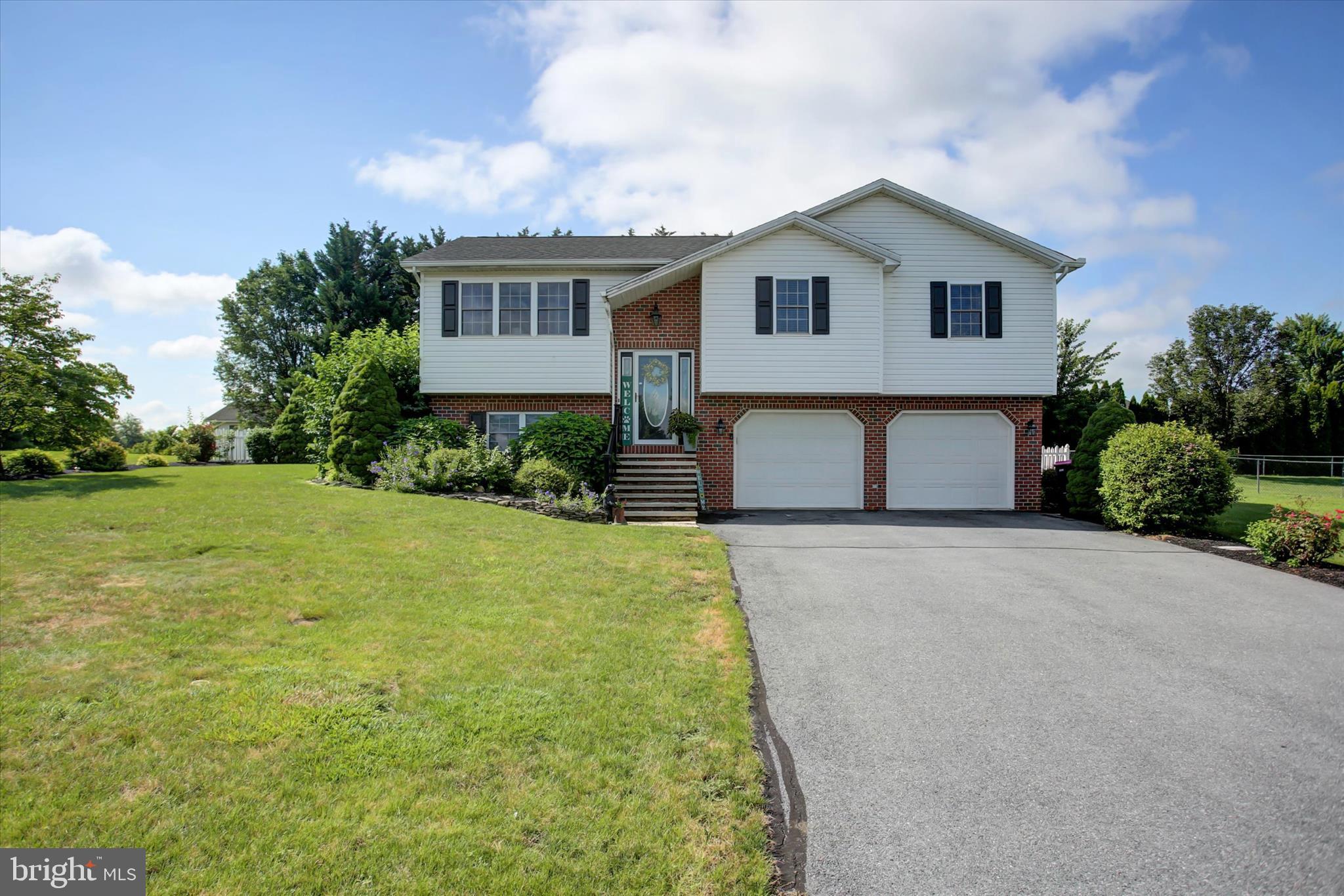 a front view of house with yard and trees