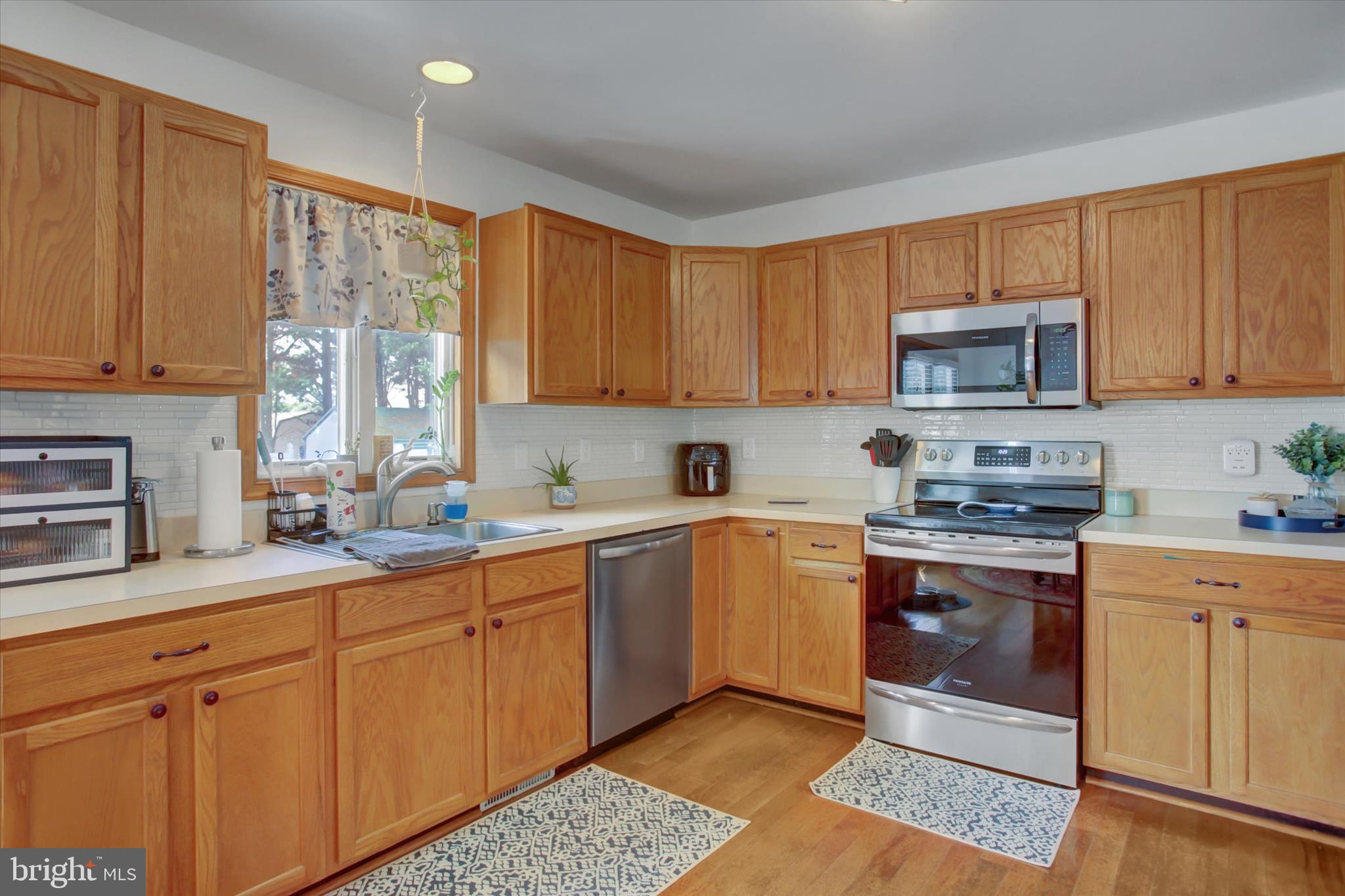 10482 Mapleton Road Shippensburg, PA 17257 - Photo 13 of 40 a kitchen with stainless steel appliances granite countertop a stove sink and cabinets