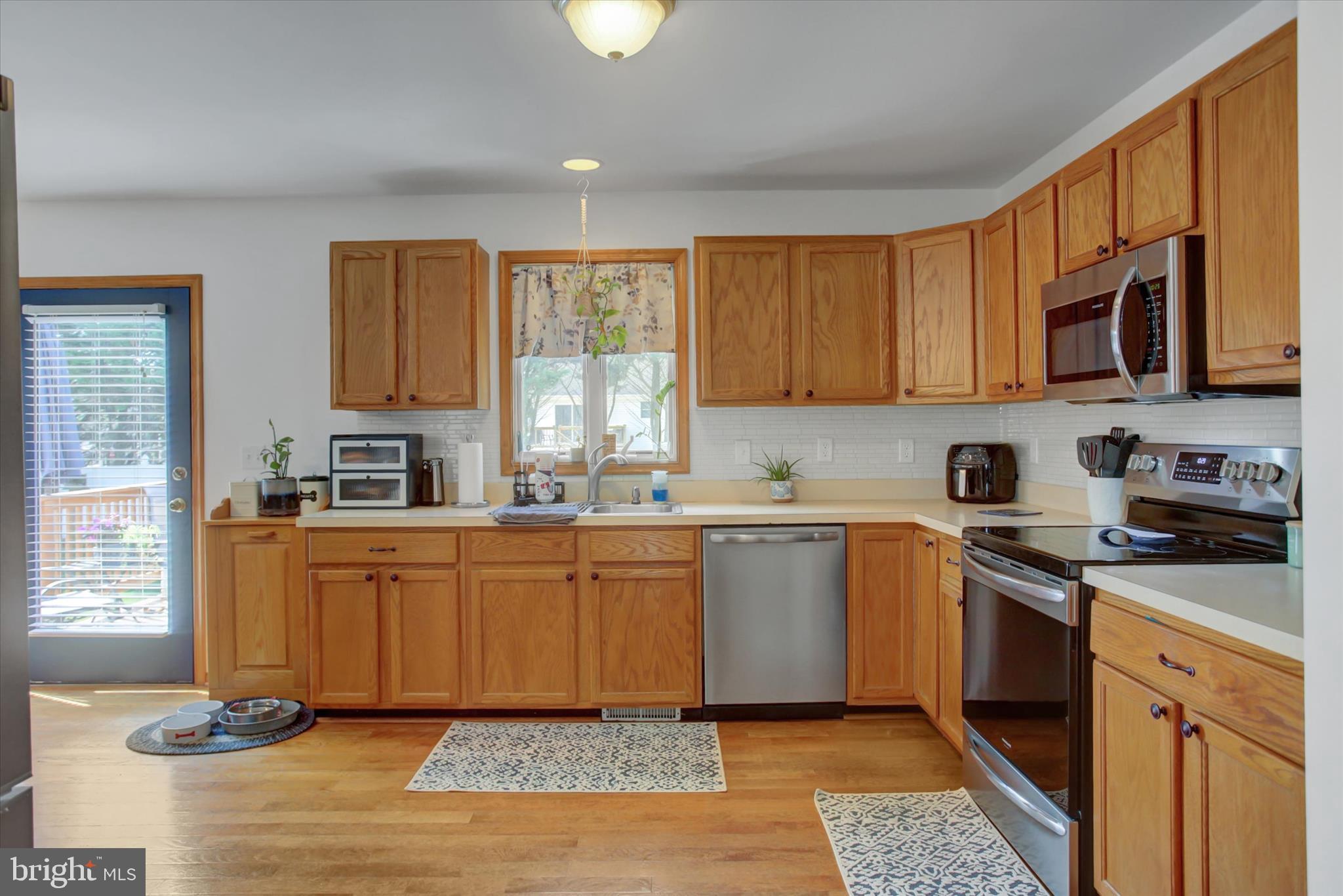 10482 Mapleton Road Shippensburg, PA 17257 - Photo 14 of 40 a kitchen with stainless steel appliances granite countertop a stove a sink and a microwave