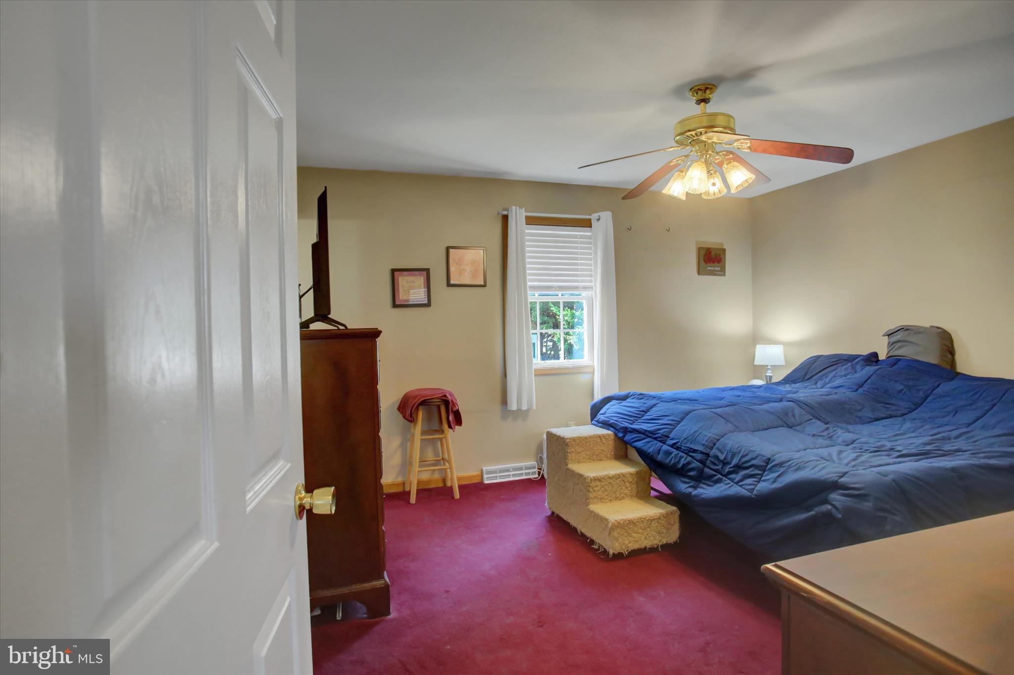 10482 Mapleton Road Shippensburg, PA 17257 - Photo 22 of 40 a bedroom with a bed and a chandelier