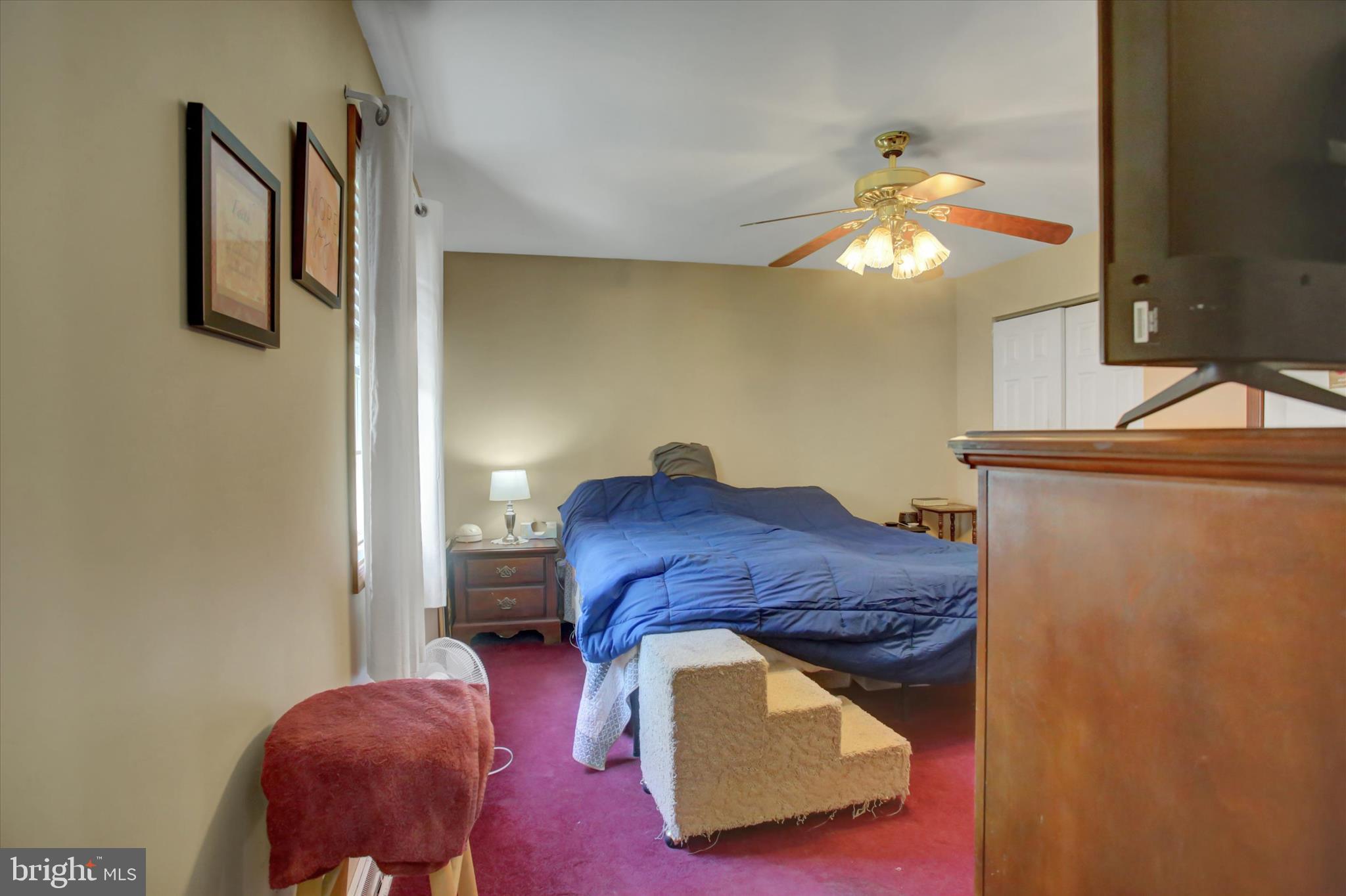 10482 Mapleton Road Shippensburg, PA 17257 - Photo 23 of 40 a bedroom with a bed and a chandelier