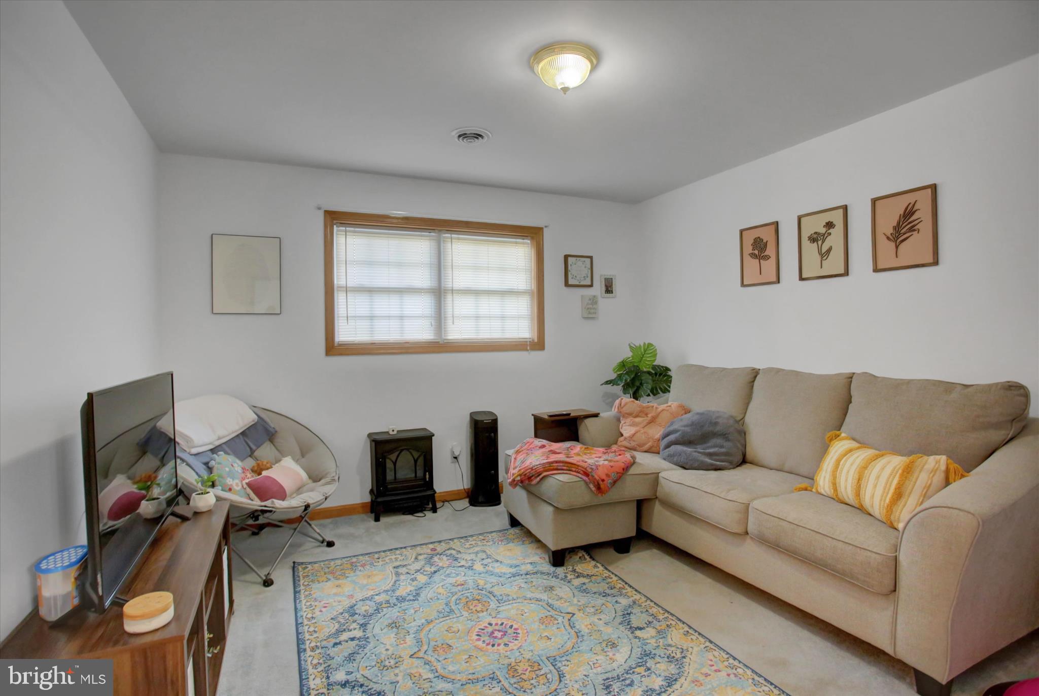 10482 Mapleton Road Shippensburg, PA 17257 - Photo 28 of 40 a living room with furniture and a flat screen tv