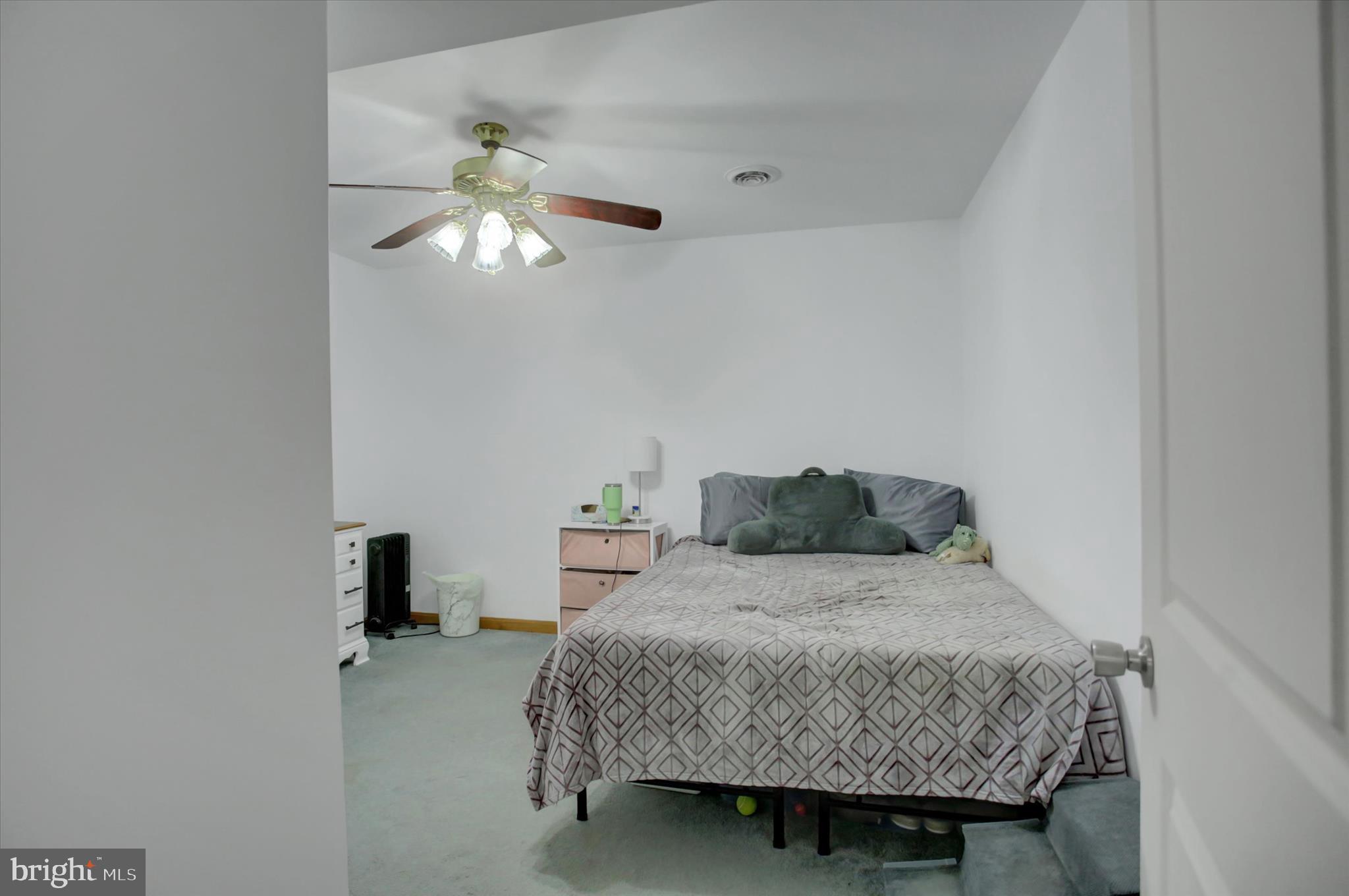 10482 Mapleton Road Shippensburg, PA 17257 - Photo 30 of 40 a bedroom with a bed and a chandelier fan