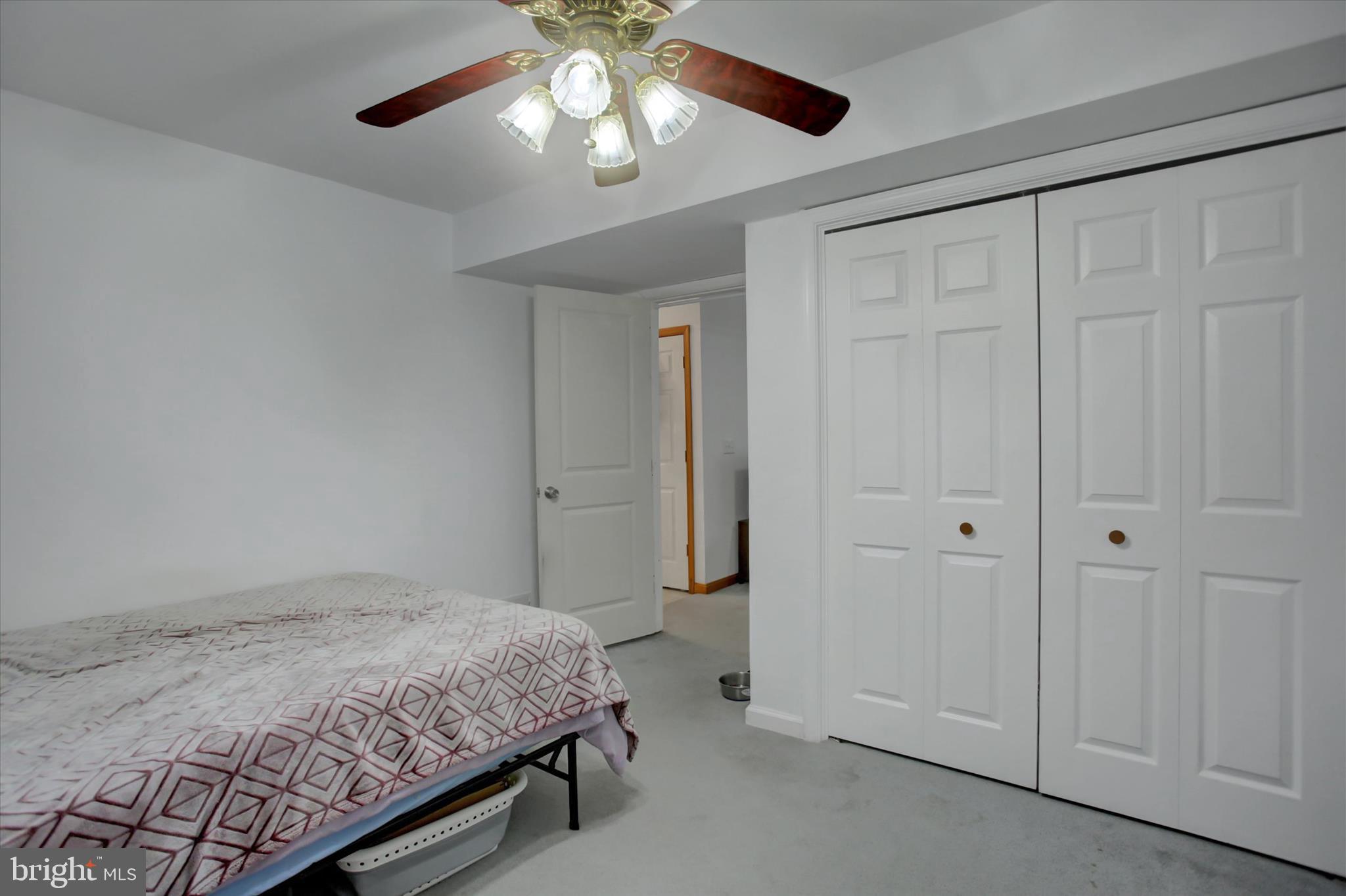 10482 Mapleton Road Shippensburg, PA 17257 - Photo 31 of 40 a spacious bedroom with a bed and a chandelier