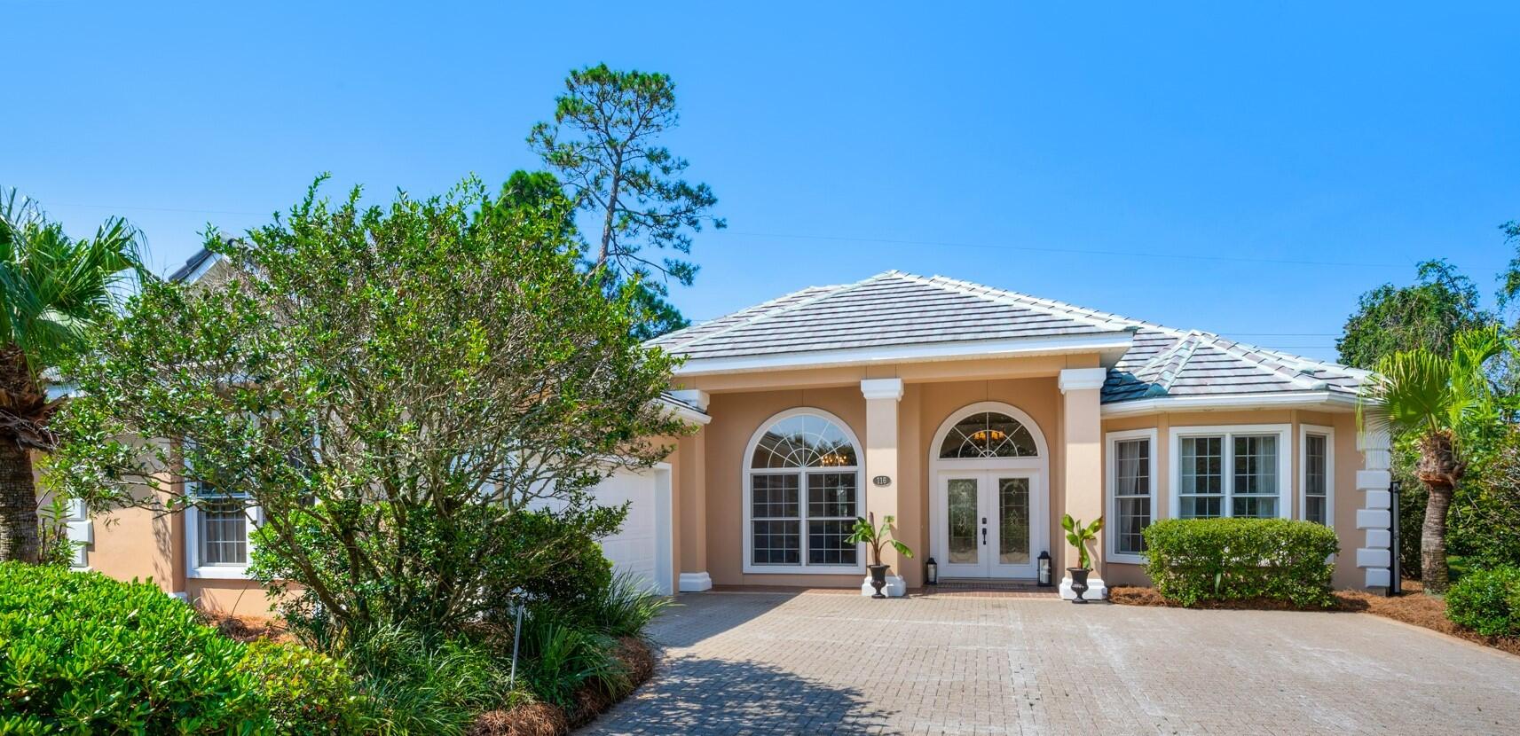 116 Tranquility Lane Destin, FL 32541 - Photo 1 of 27 front view of a house with a garden